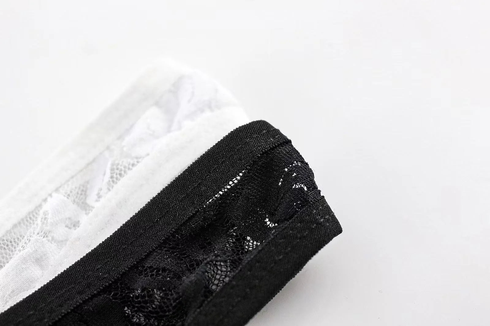 Zoomed-in shot of transparent lace and stitching on men’s erotic thong